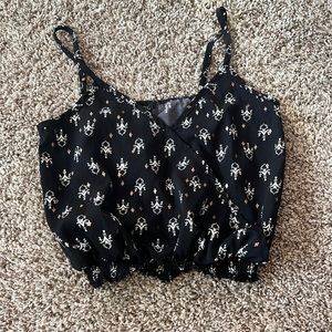 Cute black spaghetti strap crop top! Has some cool designs all around on it.